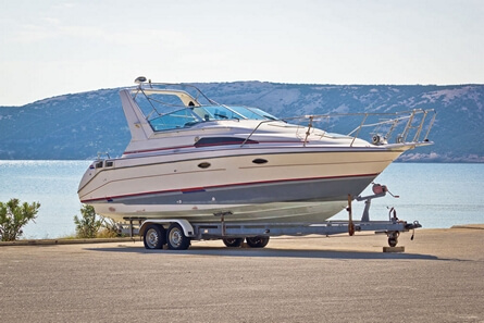 Boat on a trailer parked near water